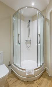 a glass shower in a bathroom with a toilet at House of Fisher - Central House in Camberley