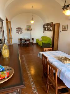 a kitchen and living room with a table and chairs at La Casa Del Nonno Raffaele- Country house in Ravello