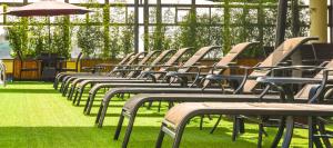 a row of empty chairs sitting on the grass at Verona Hotel and Conference Center in Ruiru