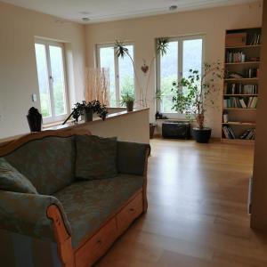 a living room with a couch and some windows at Bella Villa in Traben-Trarbach