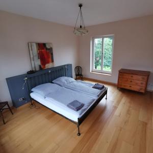 a bedroom with a bed and a wooden floor at Bella Villa in Traben-Trarbach