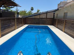 a swimming pool with blue water in a backyard at Wood House Close Beach in Marbella
