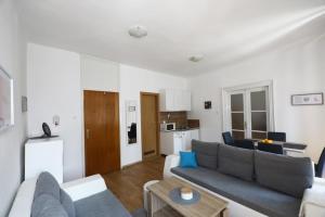 a living room with a couch and a table at ODEON Apartment And Rooms in Rijeka