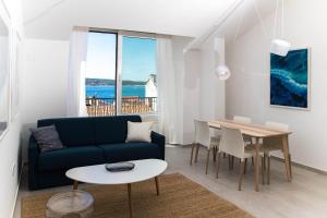 a living room with a blue couch and a table at APARTMANI VIGO in Crikvenica