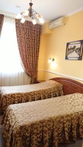 a hotel room with two beds and a window at Romantic hotel in Krasnodar