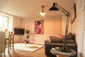 a living room with a couch and a lamp at L’Échappée Verte in Sainte-Croix-aux-Mines