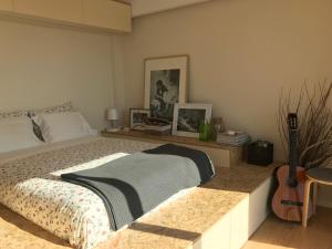 a bedroom with a bed and a guitar in it at Studio 177 in Matosinhos
