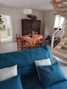 un soggiorno con divano blu e tavolo di maison entre campagne et mer a Plonéour-Lanvern