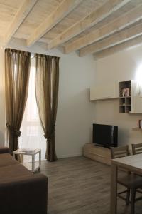 a living room with a couch and a tv at AM's Apartment in La Spezia