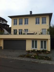 a large yellow house with a garage at Bella Villa in Traben-Trarbach