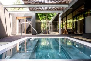 a swimming pool in the middle of a house at Sonne Lifestyle Resort - Adults Only in Mellau