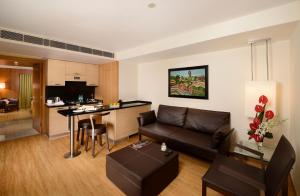 a living room and kitchen with a couch and a table at Svelte Hotel and Personal Suites in New Delhi