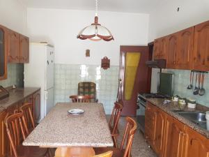 a kitchen with a table with chairs and a counter top at abitazione bellavista in Bacoli