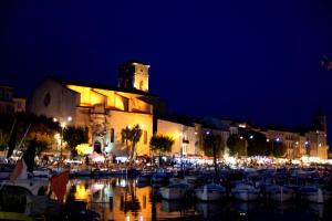 a group of boats parked in a marina at night at Jolie T2 la ciotat in La Ciotat