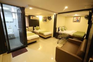 a hotel room with two beds and a window at Hotel Happyland in Mumbai