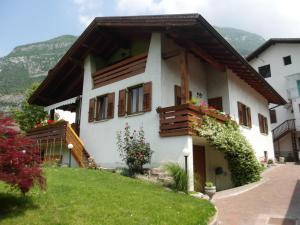 a white house with wooden balconies on a lawn at La Casa Del Gelsomino in Ospedaletto
