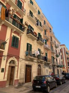 a large building with cars parked in front of it at Whiteflower Apartments in Bari +31 photos
