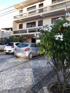 a group of cars parked in front of a building at Hotel Litoral in Aracaju