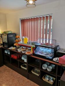 a buffet line with plates of food and drinks at Euro Hotel in Timişoara