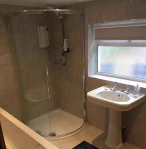 a bathroom with a shower and a sink at Springwells in Dunkeld
