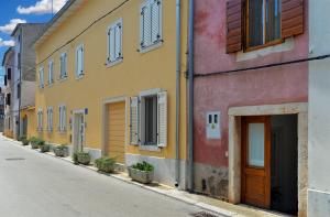 a row of buildings on the side of a street at House Silvo 1953 in Vodnjan