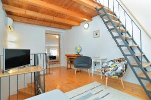 a living room with a staircase and a desk at House Silvo 1953 in Vodnjan