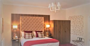 a bedroom with a bed and a lamp at Kingston Theatre Hotel in Hull