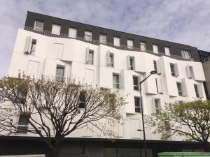 a large white building with trees in front of it at Twenty Business Flats Maisons Alfort Les Juilliottes in Maisons-Alfort