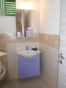 a bathroom with a sink and a mirror at agriturismo heaven in Capo Vaticano