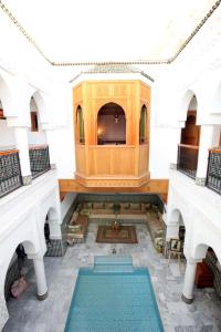 a view of a room with a tv in a building at Riad Moulay Spa in Marrakech