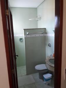 a bathroom with a toilet and a sink at Hotel Litoral in Aracaju
