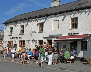 a group of people standing outside of a building at Garddfon Inn in Y Felinheli
