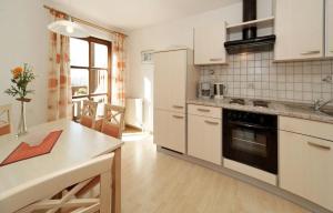 a kitchen with white cabinets and a counter top at Ferienwohnungen Krieger in Mauth