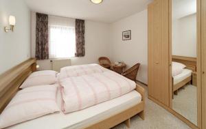 a bedroom with a large bed and a window at Ferienwohnungen Krieger in Mauth