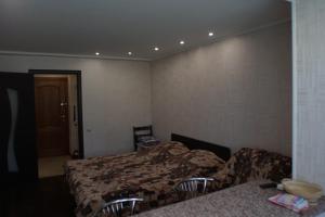 ジェレスノヴォツクにあるZheleznovodsk Apartment on Leninaのベッドルーム1室(ベッド2台、テーブル、ドア付)