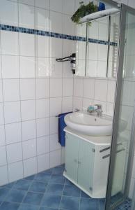 uma casa de banho com um lavatório e um espelho em Ferienwohnung Am Sundern em Tecklenburg