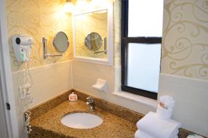 W łazience znajduje się umywalka i lustro. w obiekcie Sun Viking Lodge - Daytona Beach w mieście Daytona Beach