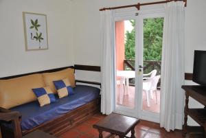 a living room with a couch and a sliding glass door at Carilo Quimey in Carilo