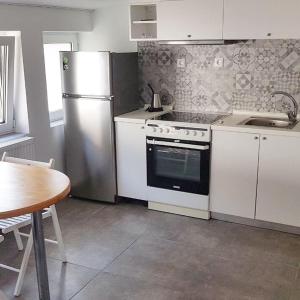 a kitchen with a stove and a refrigerator and a table at Aristotelia Gi - Panorama in Olympiada +15 photos