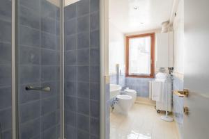 a bathroom with a shower and a toilet and a sink at Ca' Coriandolo in Venice