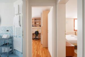 a bedroom with a bed and a desk in a room at Ca' Coriandolo in Venice