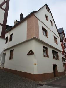 a white building with a brick at vakantiehuismoezel in Sankt Aldegund