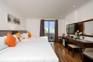 Postel nebo postele na pokoji v ubytování Roliva Hotel & Apartment Danang + 37 fotografií