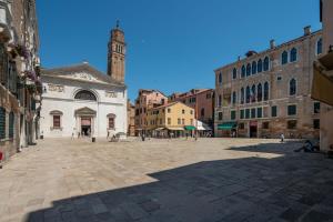 a city square with a clock tower in the distance at Ca' Coriandolo in Venice
