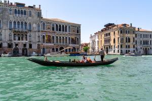 a group of people in a gondola in the water at Ca' Coriandolo in Venice