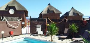 a group of houses with a pool in front of it at Honne-Pondokkies in Hondeklipbaai