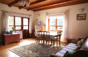 a living room with a table and chairs at Pod Dębem in Giby