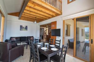 a dining room and living room with a table and chairs at Krasas Villa in Protaras