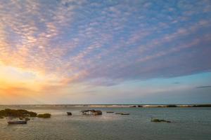 a group of boats in the water under a cloudy sky at CasaMar Guriú in Guriú