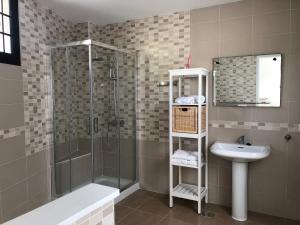 a bathroom with a shower and a sink at Los Peces de Gáldar in Sardina +19 photos
